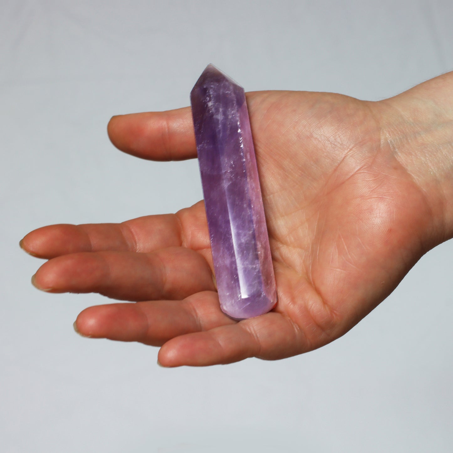 Amethyst Quartz Crystal Hexagonal Towers Obelisks Wands. Esoteric decor,spiritual gifts from our online new age metaphysical store based in Melbourne Australia. Shown in hand for size reference.