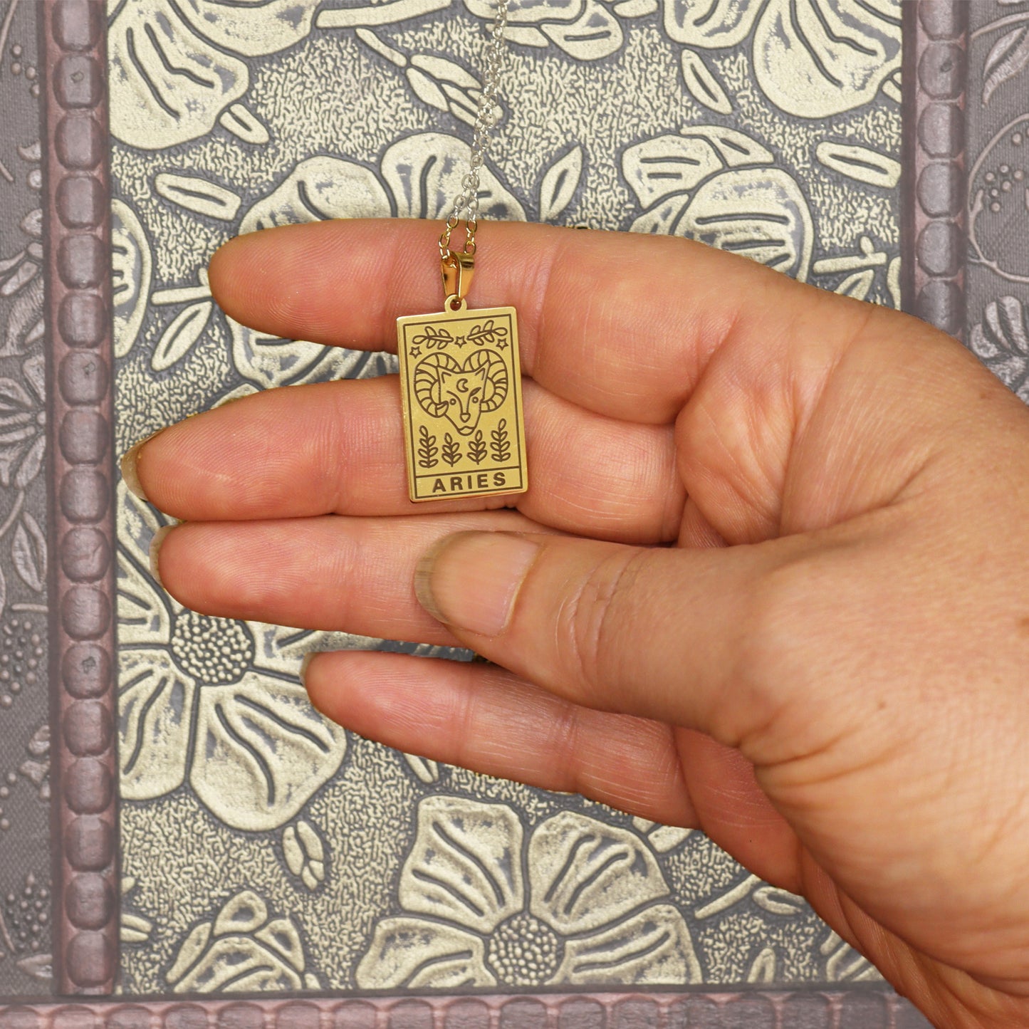 Aries birthday gift necklace-pendant, Horoscope star-sign jewellery gifts from our Bridge Between Worlds. Melbourne Metaphysical store. Unique astrological celestial, esoteric, spiritual gift for the Aries in your life. Shown in hand for size reference.