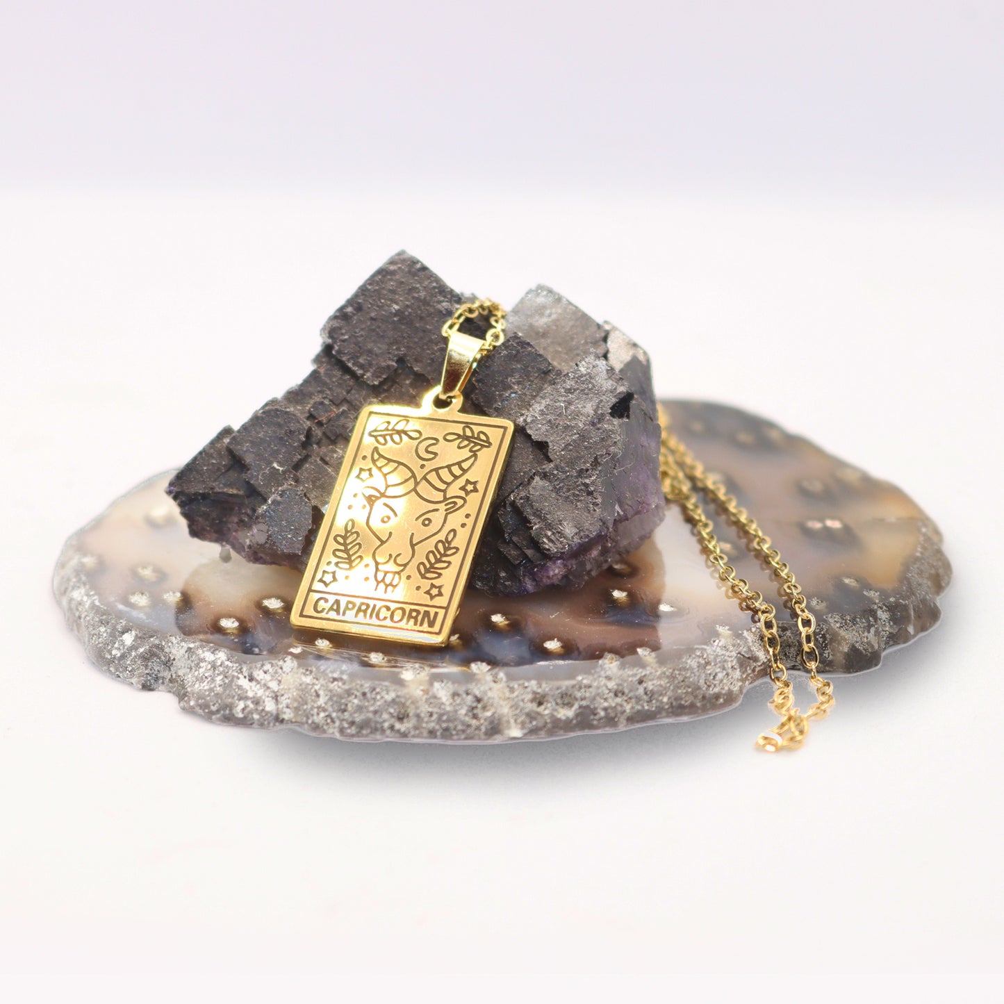 Capricorn birthday gift necklace-pendant, Zodiac star-sign jewellery displayed with crystals.