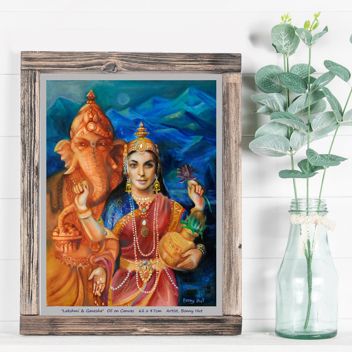 Lakshmi and Ganesh wall Art Print, Hindu mythology. Goddess of prosperity and beauty. Elephant God who is the remover of opstacles. Reproduced from an original oil painting. Framed print on white wall.
