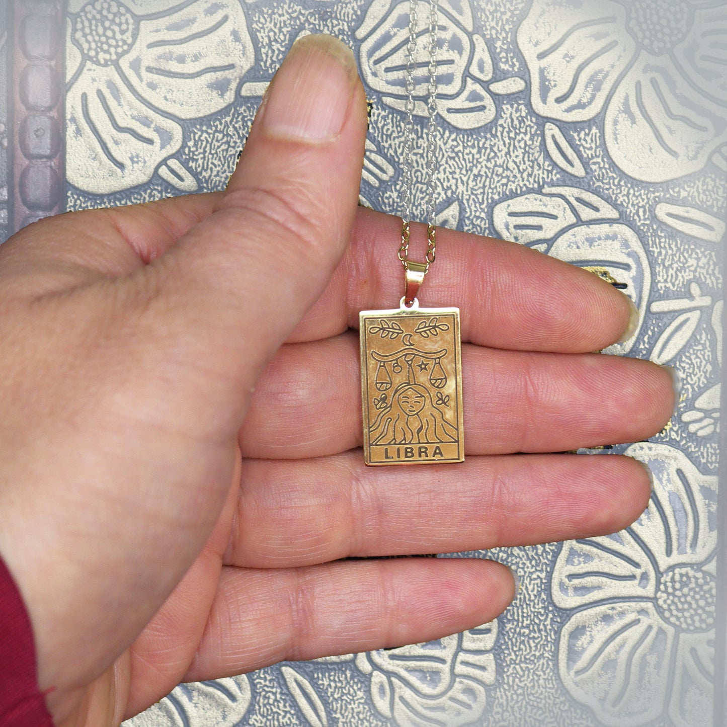 Libra birthday gift necklace-pendant, Zodiac star-sign jewellery for Astrology lovers and spiritual esoteric gifts. Displayed here in hand.