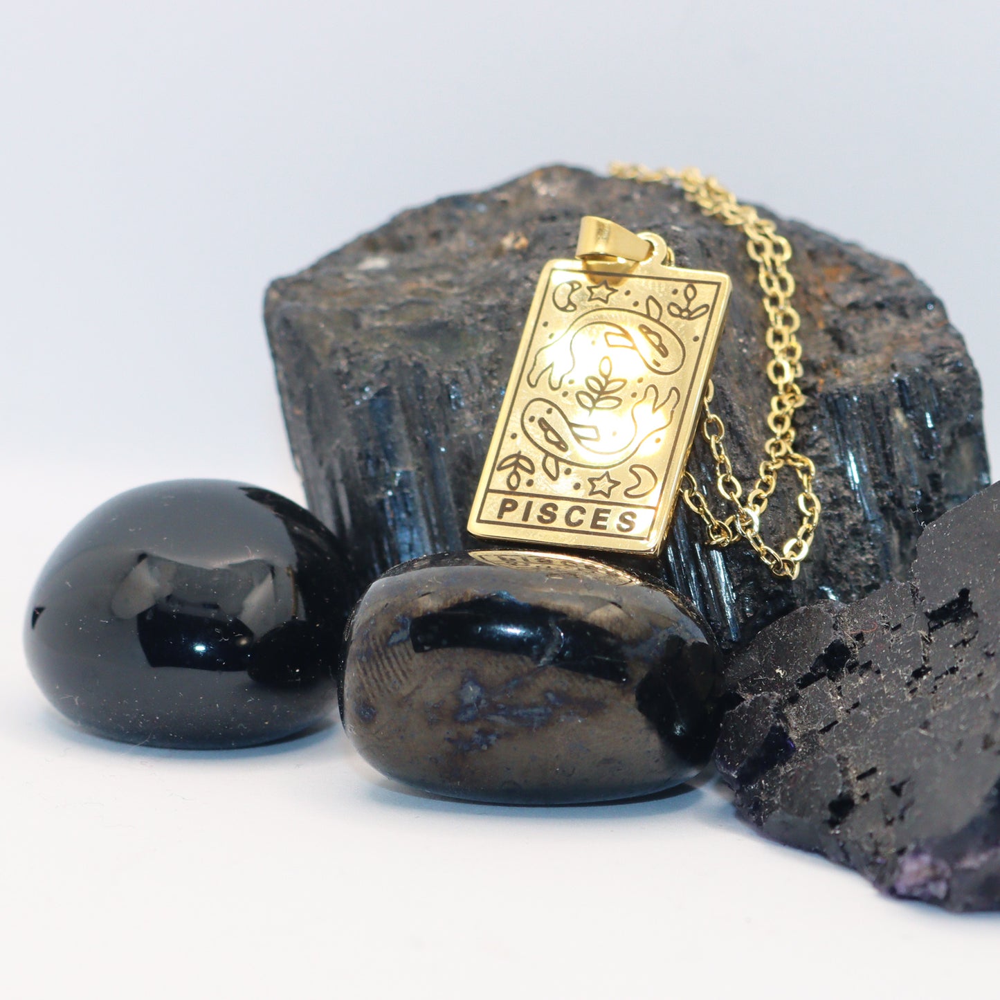Pisces birthday gift necklace-pendant, Zodiac star-sign jewellery for horoscope and astrology lovers. Displayed here on crystal rocks.