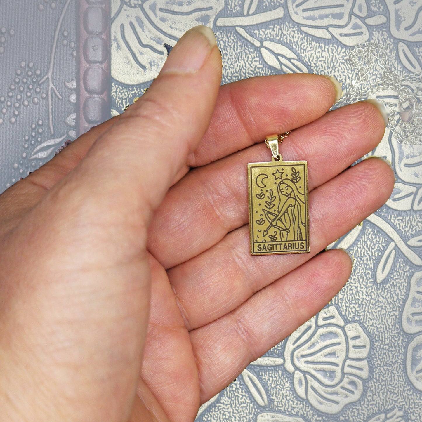 Sagittarius birthday gift necklace-pendant, Zodiac star-sign jewellery for horoscope astrological lovers. Spiritual esoteric gifts for her. Displayed in hand.