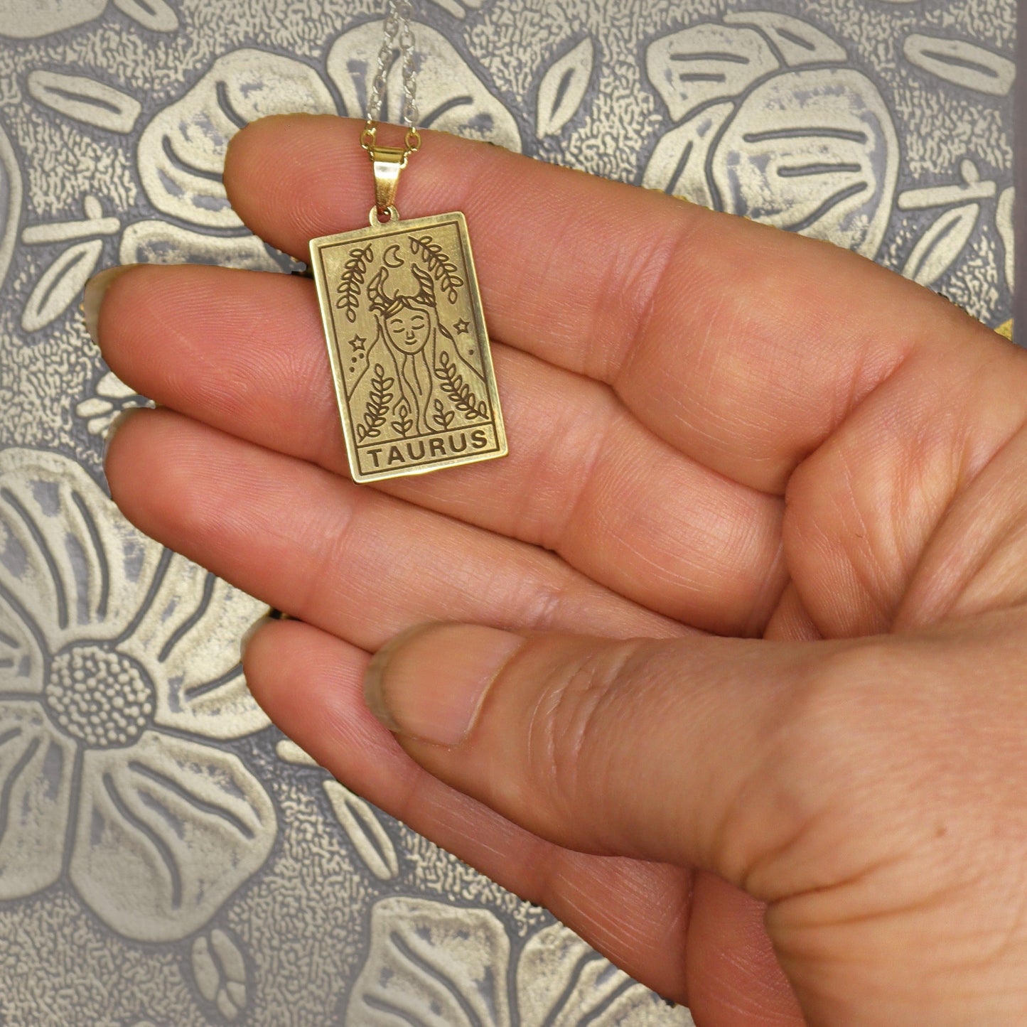 Taurus birthday gift necklace-pendant, Zodiac star-sign jewellery. Spiritual Esoteric gifts for her. Great for horoscope astrology lovers. Shown in hand.