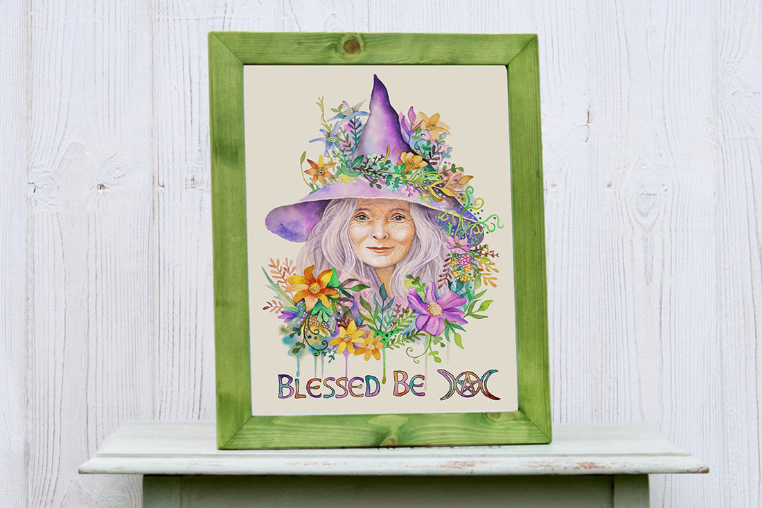 Framed artwork of a witchy woman with a floral witch hat and 'Blessed Be' text on a wooden surface.

Downloadable, printable clip art reproduced from a hand-painted wiccan / pagan watercolor painting. An instant-access digital product. 