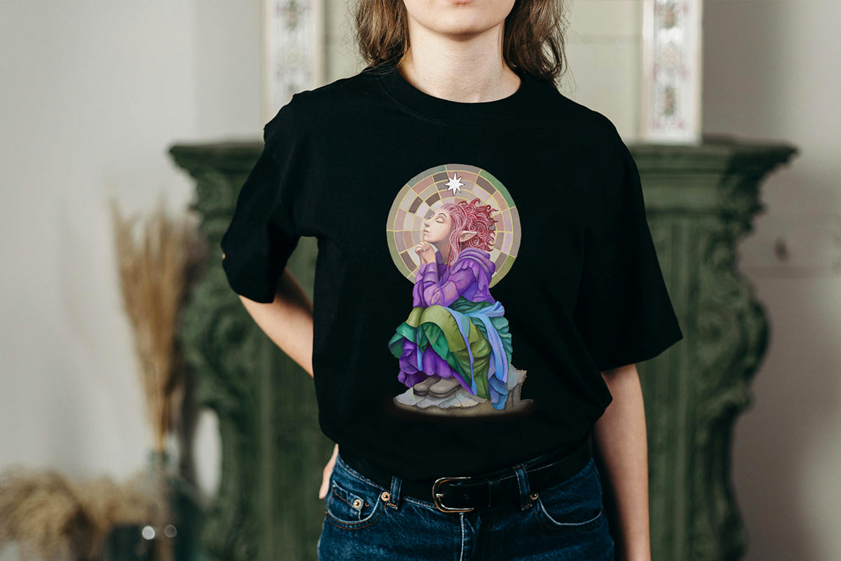 Person wearing a black t-shirt with a colorful graphic design of a celestial pixie character in a robe meditating on a rock.

Downloadable, printable wall art reproduced from a hand-painted  gouache painting. Instant access digital product. Great gifts for her.
