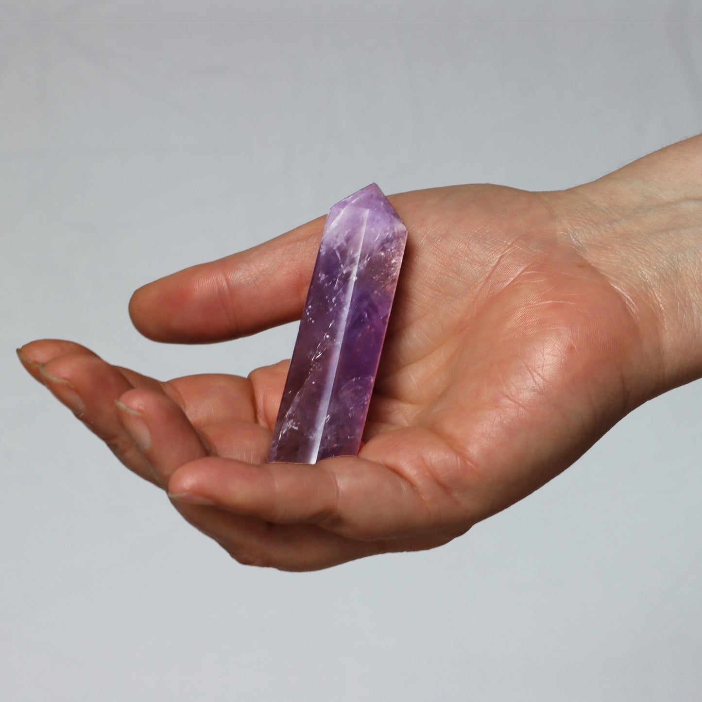 Amethyst Quartz Crystal Hexagonal Towers Obelisks Wands. Esoteric decor,spiritual gifts from our online new age metaphysical store based in Melbourne Australia. Also shown in hand for size reference. 